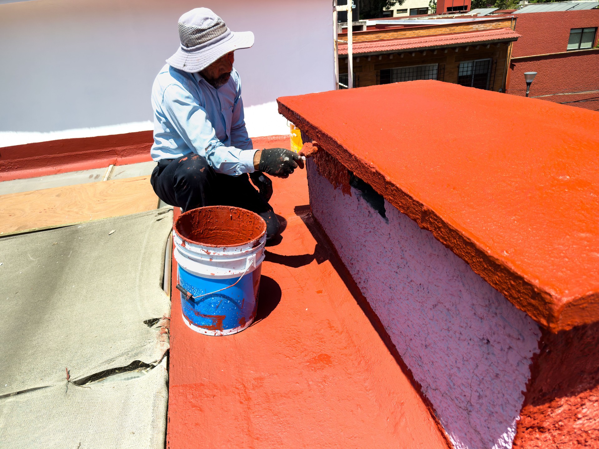 Applying waterproofing coating to a rooftop with solar panels